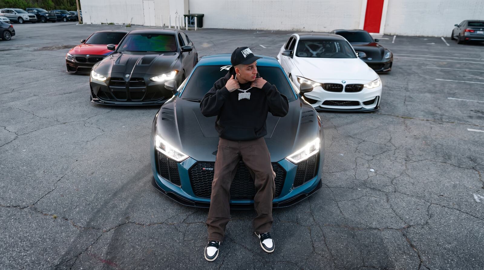 Nick with the crew's cars in the lot