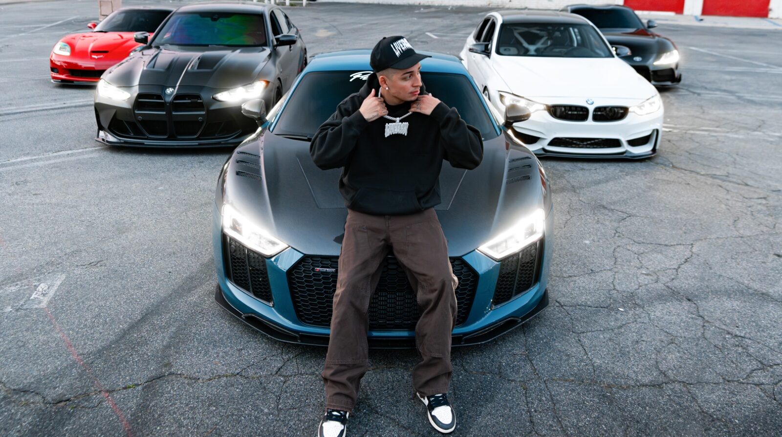 Nick standing with the cars in the lot